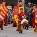 The parade begins and drums echo off the ancient stone walls.